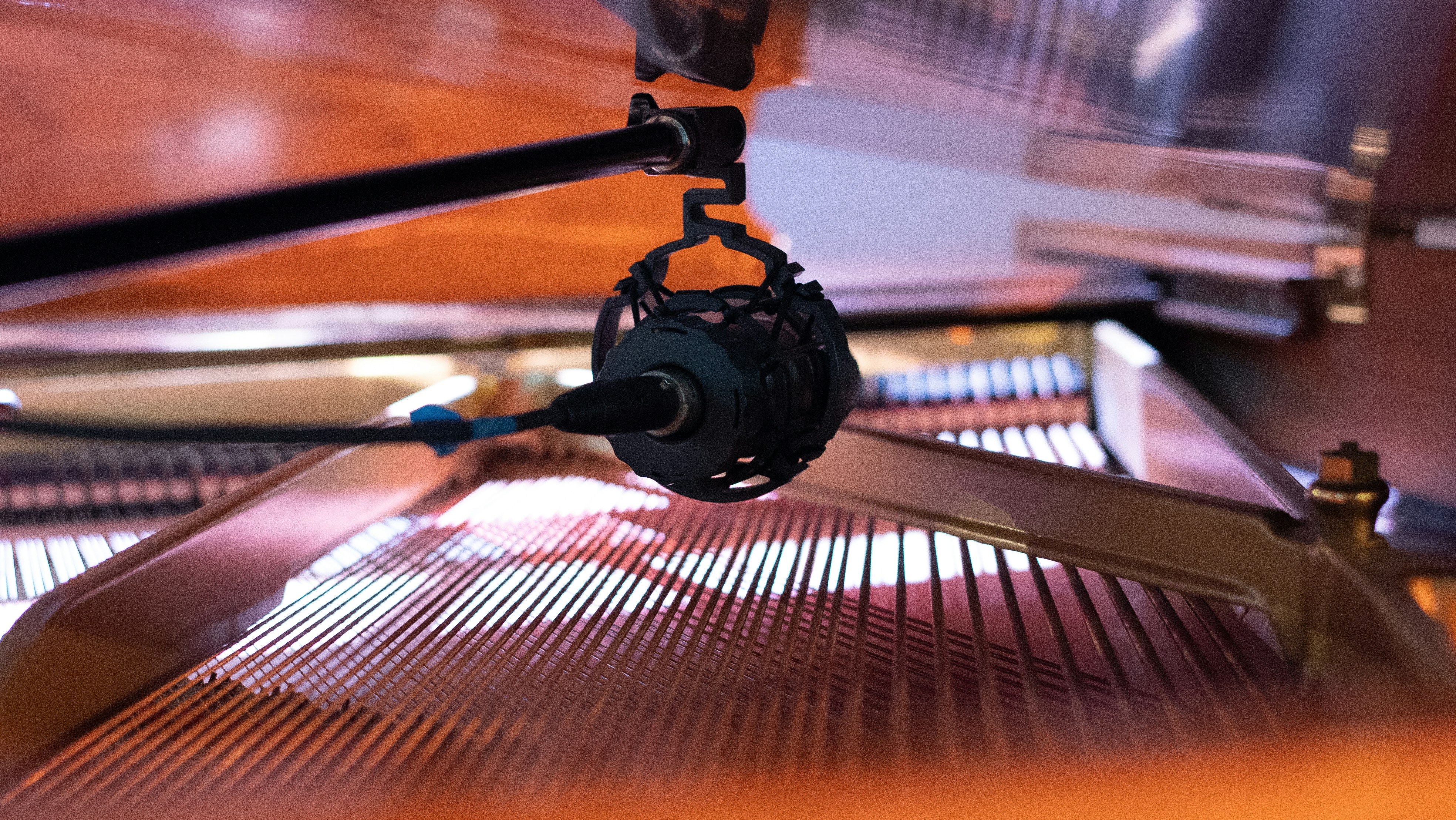 Agentic Recommender - microphone over piano strings in a recording studio